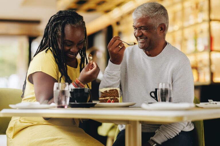 A couple laughing together at a café.