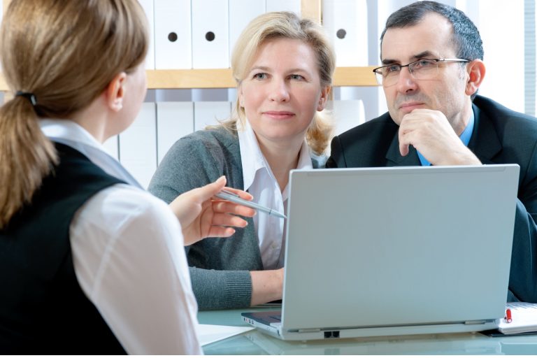 A couple talking to a financial planner.