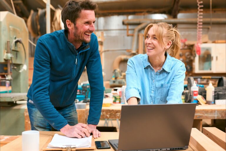 Two people in a woodwork workshop.
