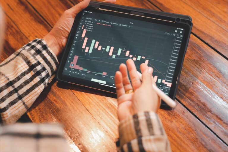 A person looking at investment performance on a tablet.