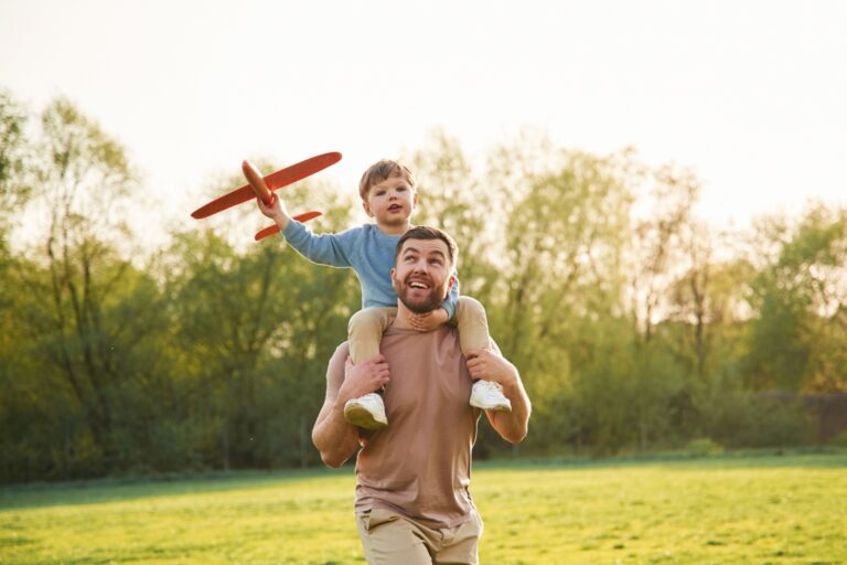 A father with a child sitting on his shoulders.