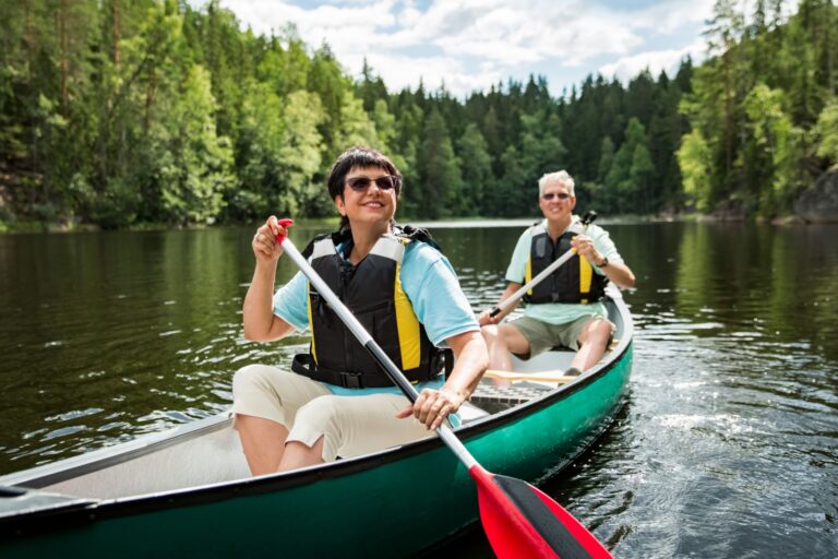 A couple on holiday taking a canoe ride.
